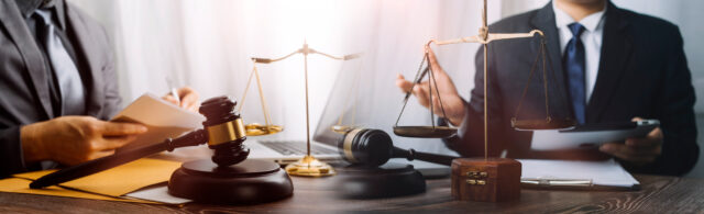 Cyber security is an important part of an attorneys office insurance pllan in Maryland by Huff Insurance. Attorneys working with scales of justice and a gavel, symbolizing legal practice and the importance of protecting sensitive information from cyber threats.